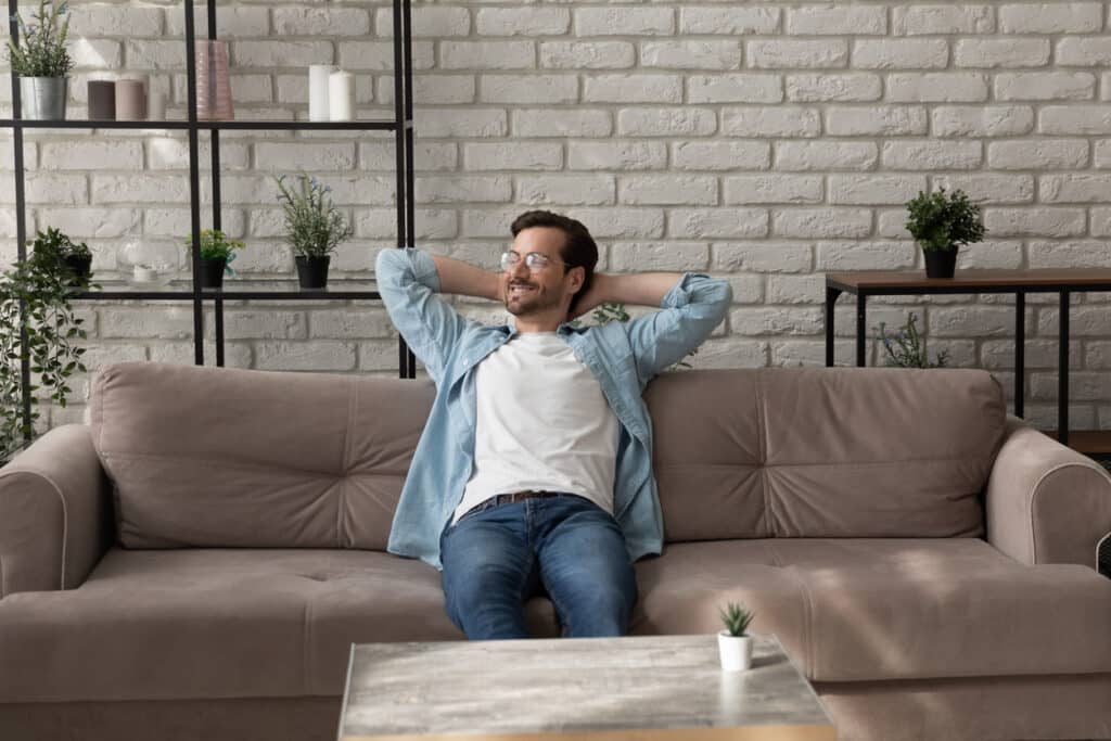 man relaxing on sofa