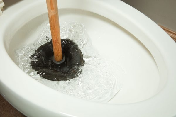 plunger-working-on-toilet-clog-royalty-free-image-185122993-1540318418